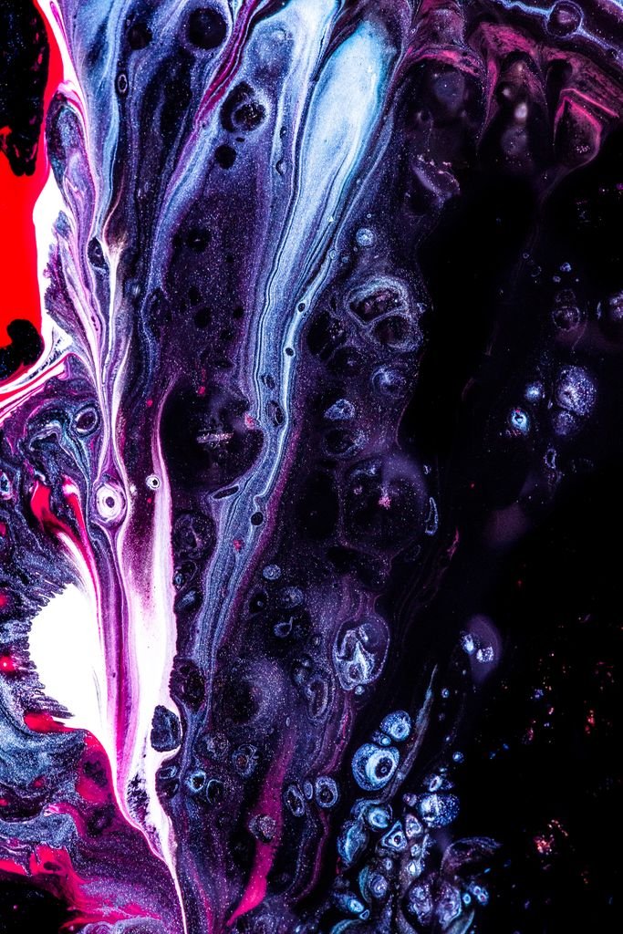 Dynamic abstract liquid artwork featuring vivid hues of red, black, and white with flowing textures.